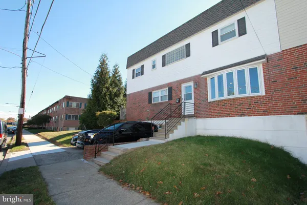 a couple of cars parked in front of a house