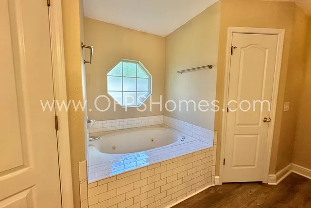 a bathroom with a tub and a shower