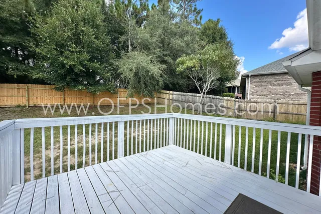 a view of balcony with wooden floor and fence