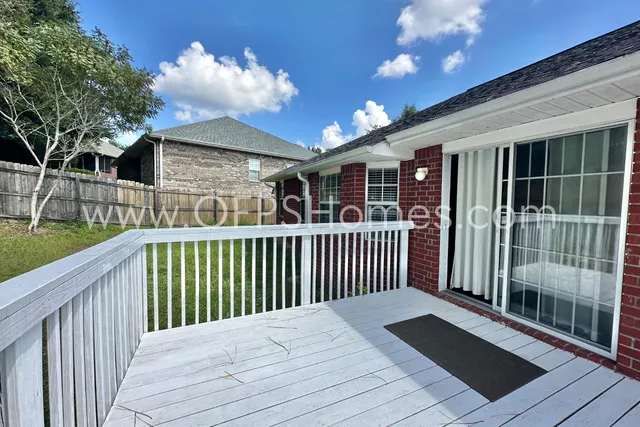 a view of a house with a wooden deck