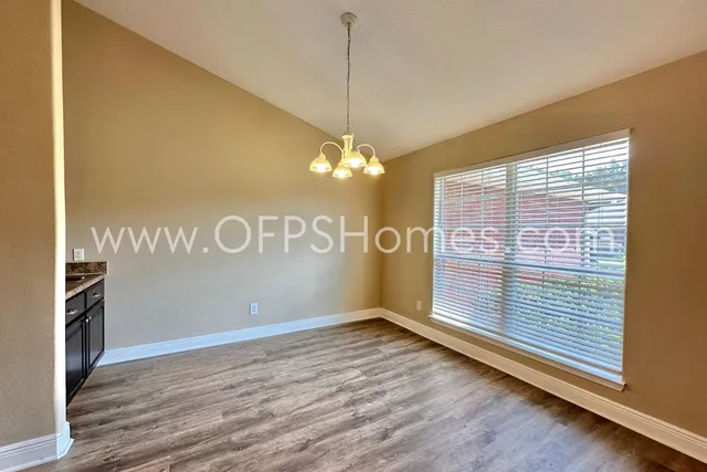a view of a room with window entryway and wooden floor