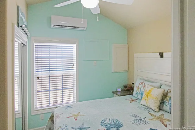 a bedroom with a bed and a window