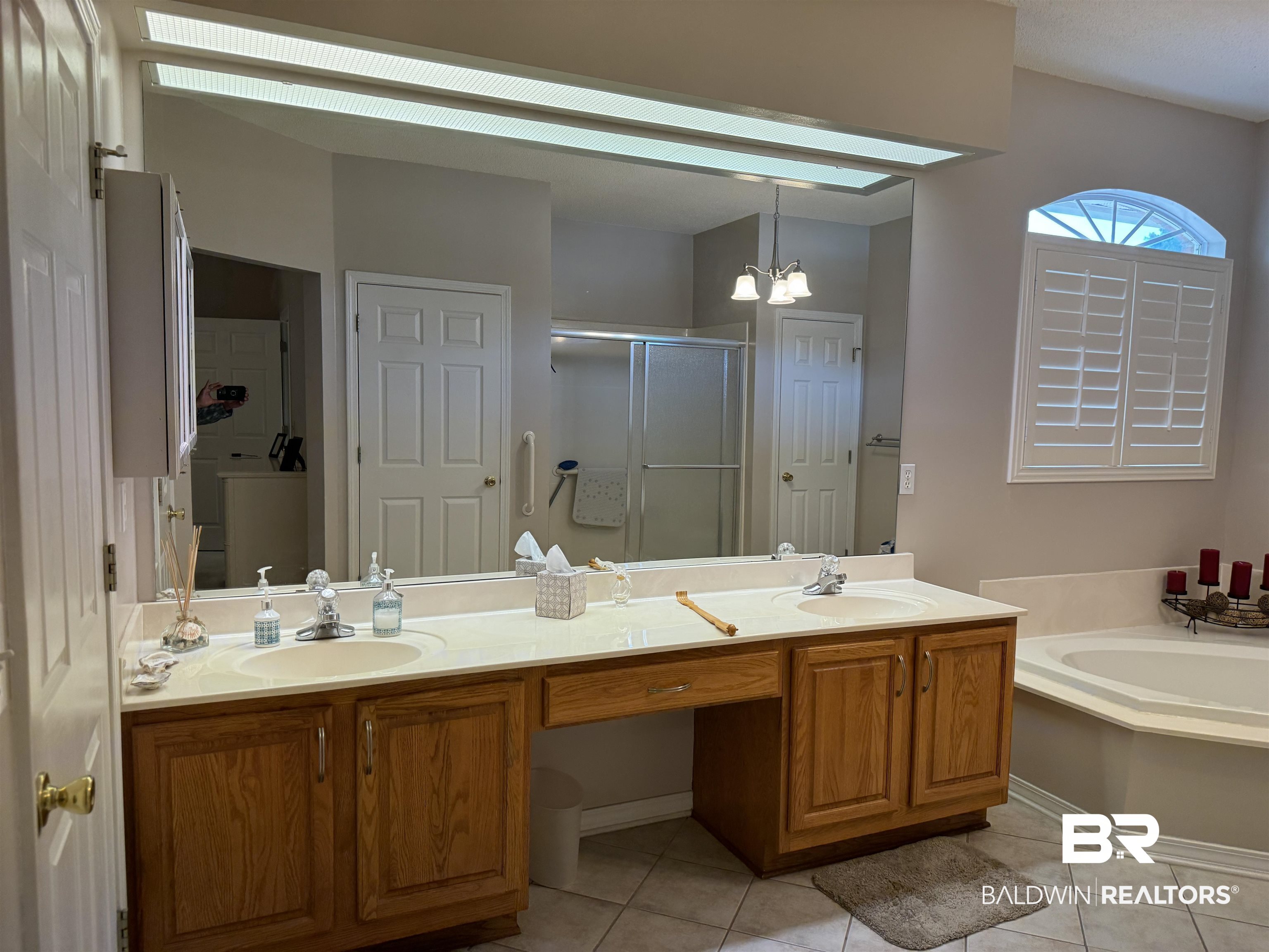 9139 Clubhouse Drive Foley, AL 36535 - Photo 24 of 30 Bathroom with independent shower and bath, dual vanity, an inviting chandelier, and tile patterned flooring