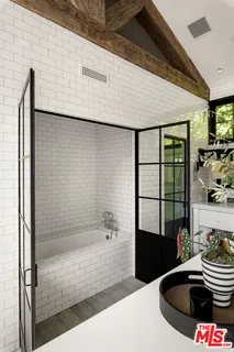a spacious bathroom with a double vanity sink a mirror and shower