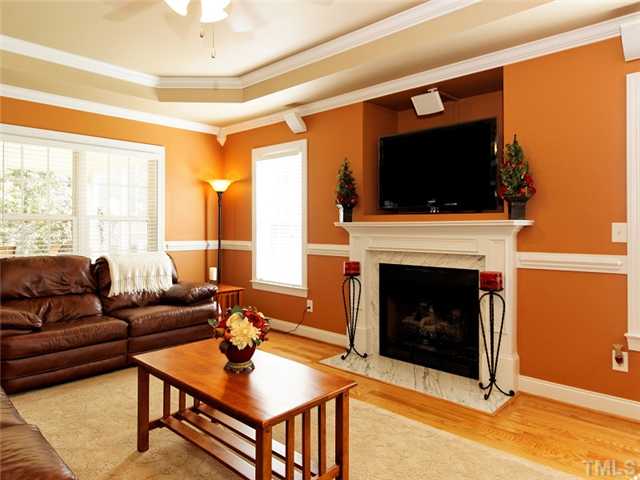 149 Alfred Court Raleigh, NC 27603 - Photo 5 of 24 a living room with furniture a flat screen tv and a fireplace