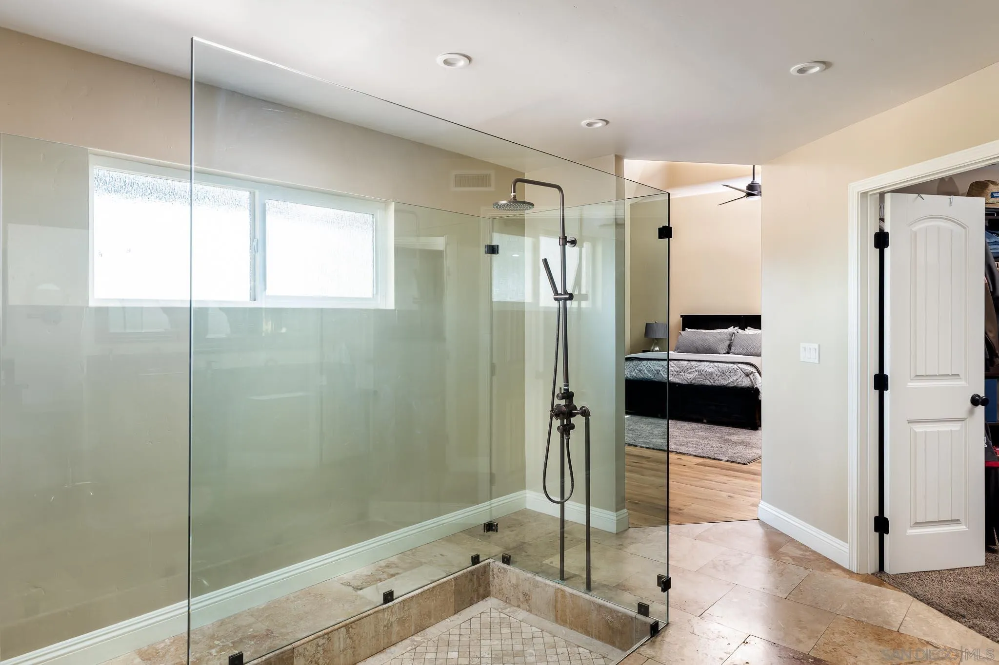 13647 Orchard Gate Road Poway, CA 92064 - Photo 17 of 43 a bathroom with a glass shower door and a bathtub