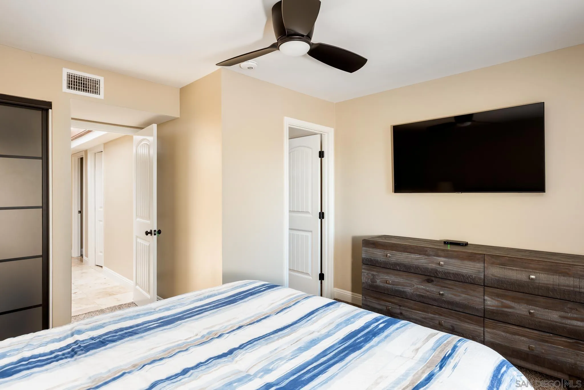 13647 Orchard Gate Road Poway, CA 92064 - Photo 23 of 43 a bedroom with a bed and a flat screen tv