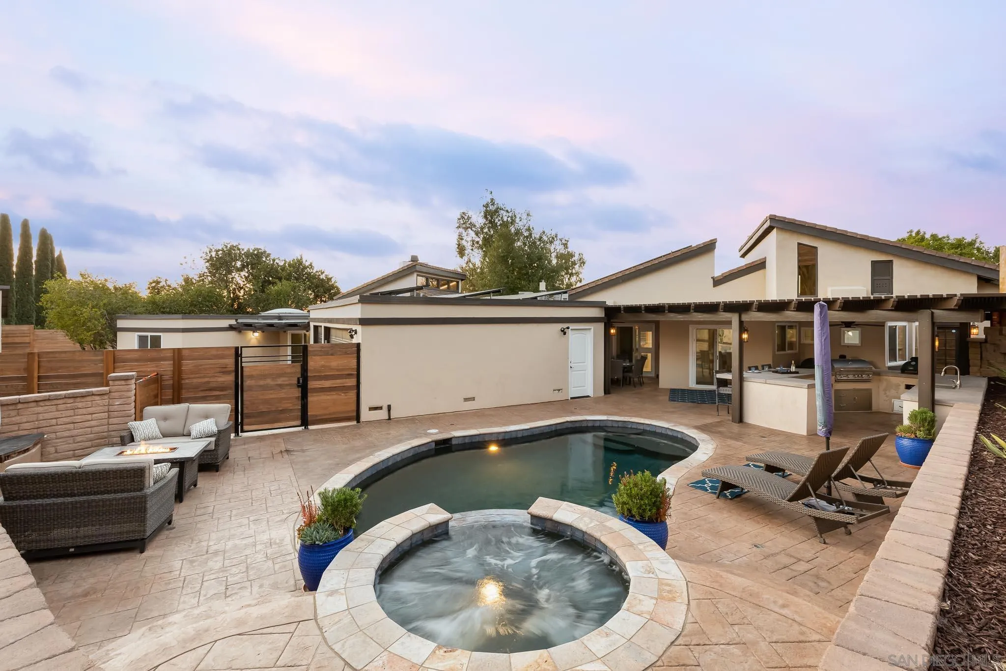 13647 Orchard Gate Road Poway, CA 92064 - Photo 26 of 43 a front view of a house with swimming pool having outdoor seating