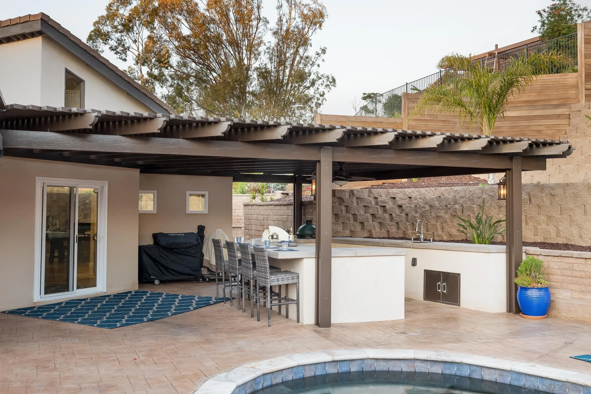 13647 Orchard Gate Road Poway, CA 92064 - Photo 28 of 43 a view of a patio with table and chairs and potted plants