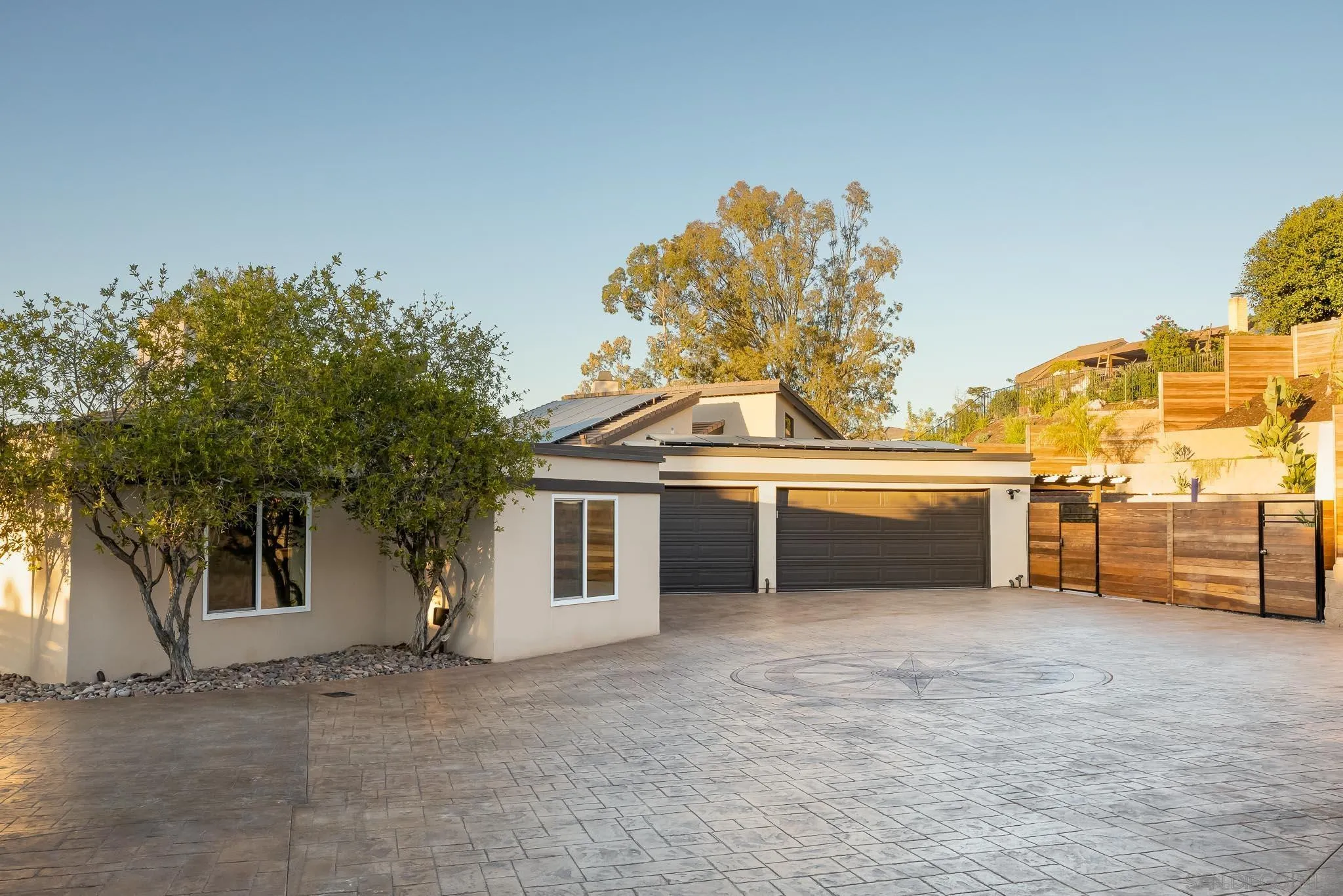 13647 Orchard Gate Road Poway, CA 92064 - Photo 31 of 43 a view of a white house with a large tree and a yard