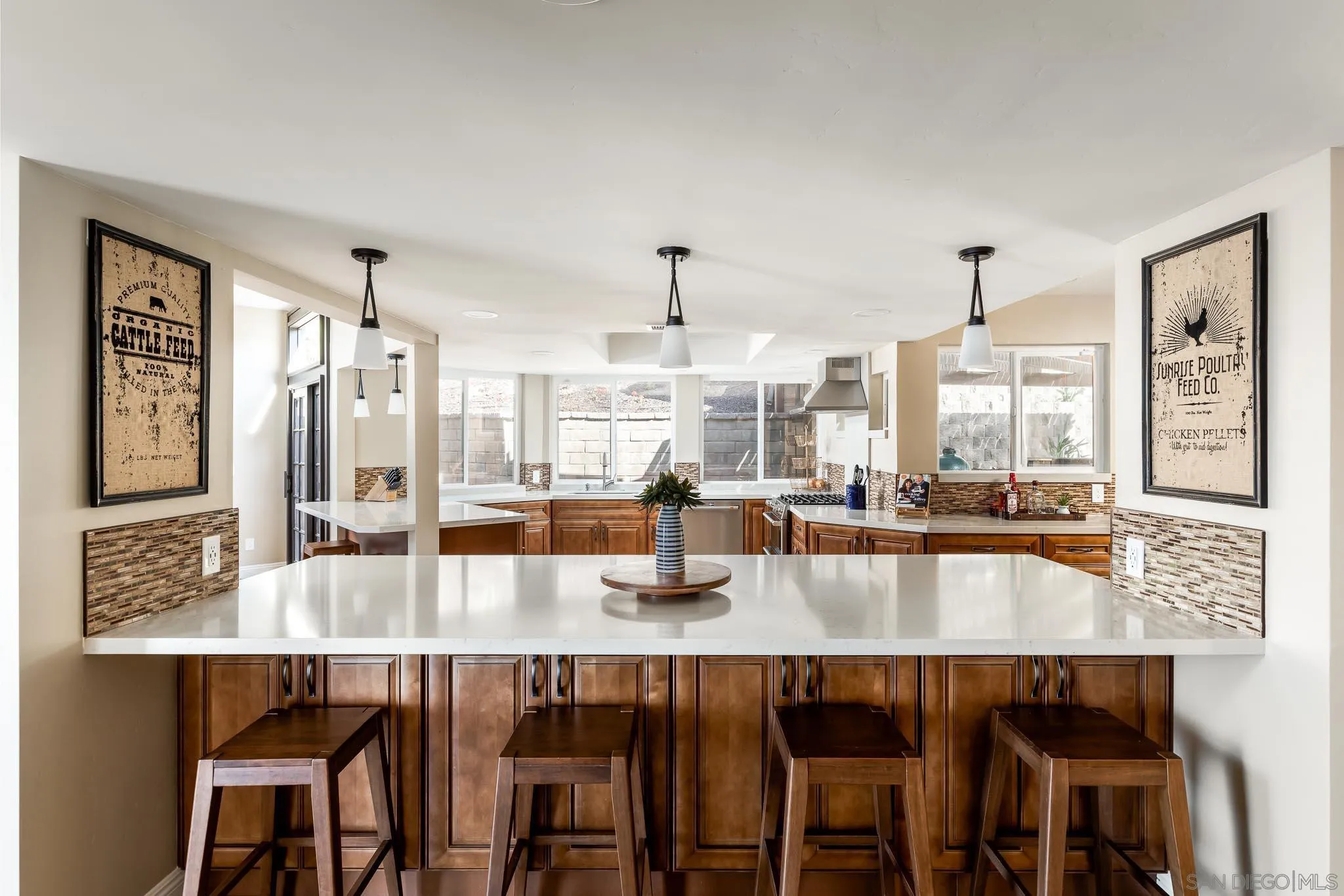 13647 Orchard Gate Road Poway, CA 92064 - Photo 9 of 43 a dining hall with stainless steel appliances granite countertop a table chairs and couches