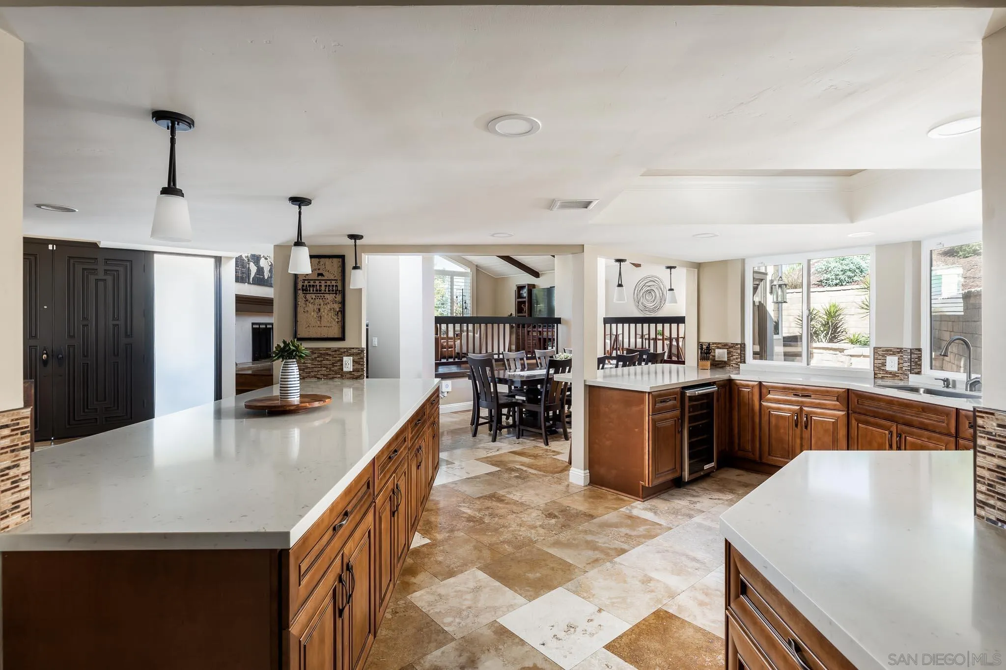 13647 Orchard Gate Road Poway, CA 92064 - Photo 10 of 43 a kitchen with a refrigerator a stove a sink dishwasher a oven with a dining table and chairs