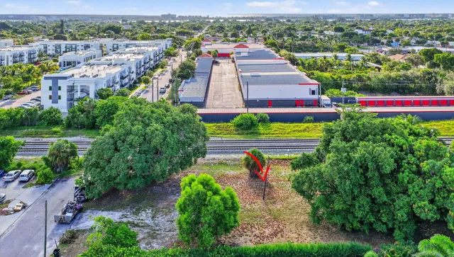 an aerial view of residential houses with outdoor space and street view
