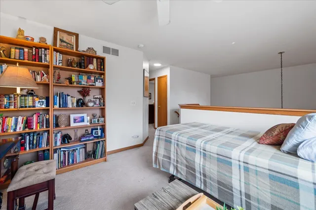 a bedroom with a bed and a book shelf