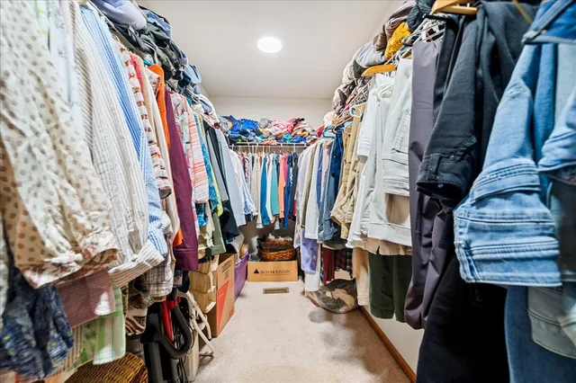 a view of walk in closet with clothes