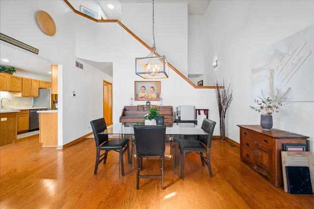 a view of a dining room with furniture wooden floor and chandelier