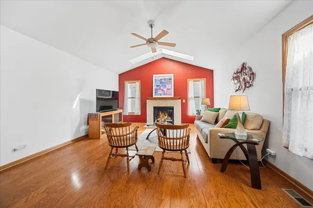 a living room with furniture a fireplace and a window
