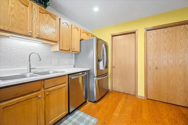 a kitchen with stainless steel appliances a refrigerator and cabinets