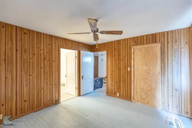a view of a room with a window and a ceiling fan