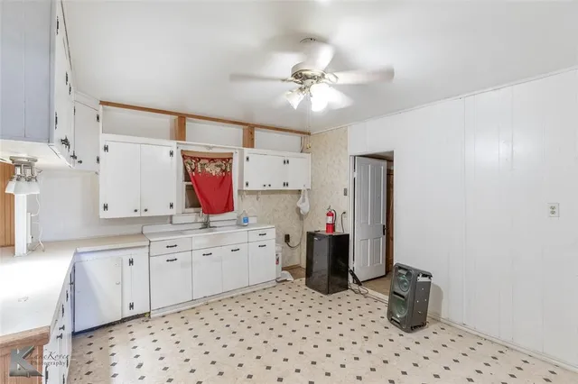 a kitchen with a sink dishwasher a stove and a refrigerator