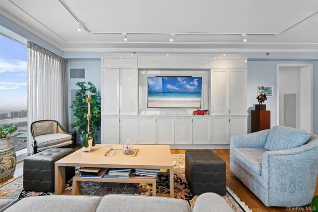 a living room with furniture and a potted plant