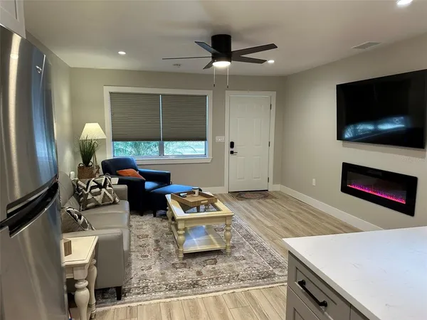 a kitchen with granite countertop kitchen island stainless steel appliances a dining table and chairs