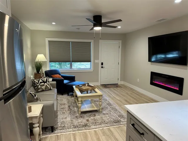 a kitchen with granite countertop kitchen island stainless steel appliances a dining table and chairs