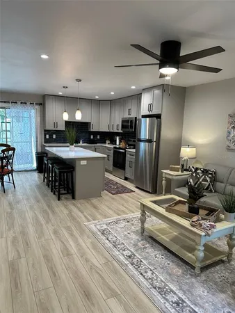 a dining room with furniture and wooden floor