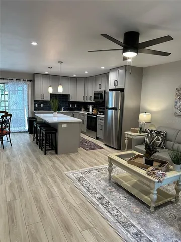 a dining room with furniture and wooden floor