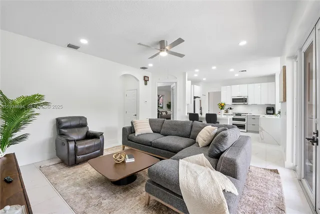 a bathroom with a granite countertop sink a toilet and shower