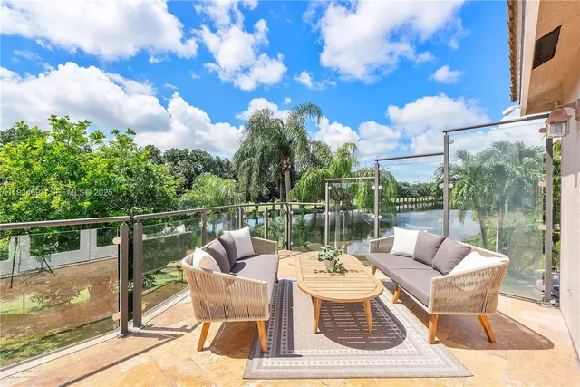 an aerial view of a house with outdoor space and a lake view