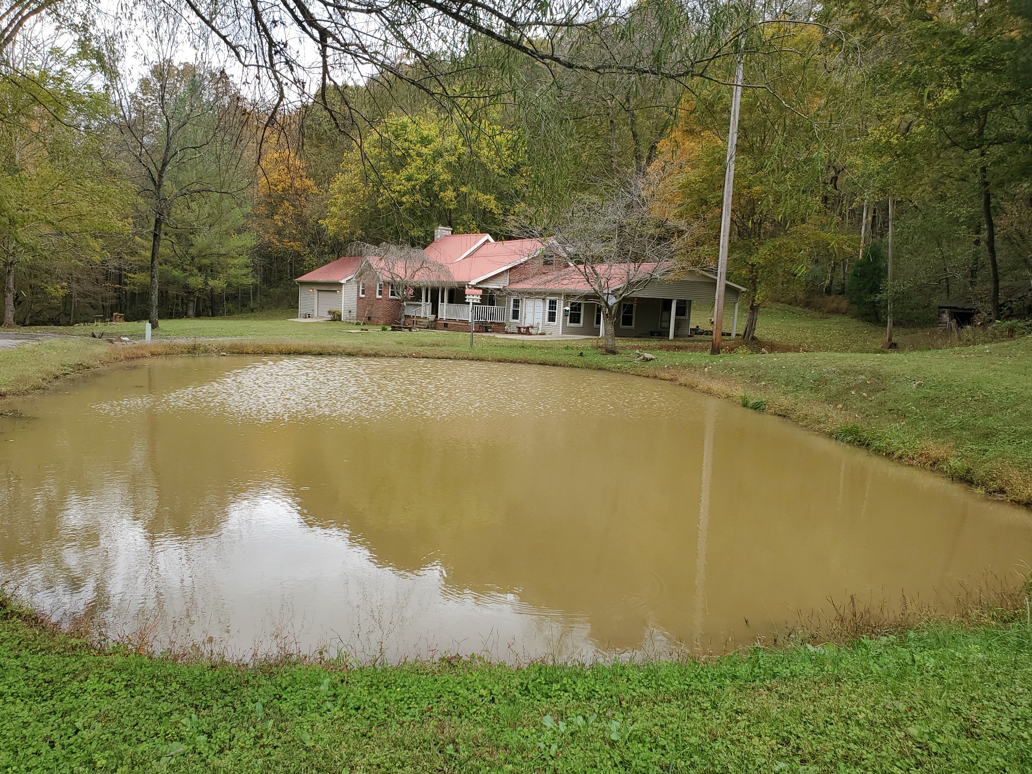 a view of a house with a yard and sitting area