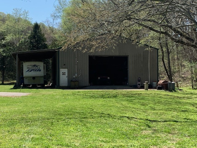 3979 Lem Davis Road Cunningham, TN 37052 - Photo 9 of 39 a front view of a house with a garden