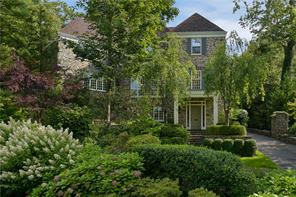 9 Crows Nest Road Bronxville, NY 10708 - Photo 1 of 1 a view of a house with brick walls and a yard with plants and large trees