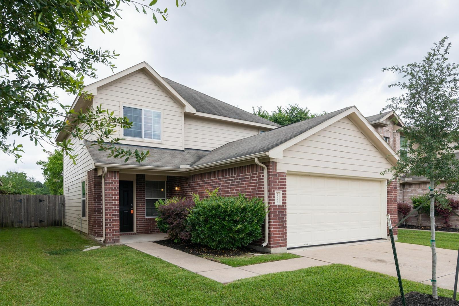 13030 Ristina Circle Houston, TX 77048 - Photo 2 of 10 a front view of a house with a yard and garage