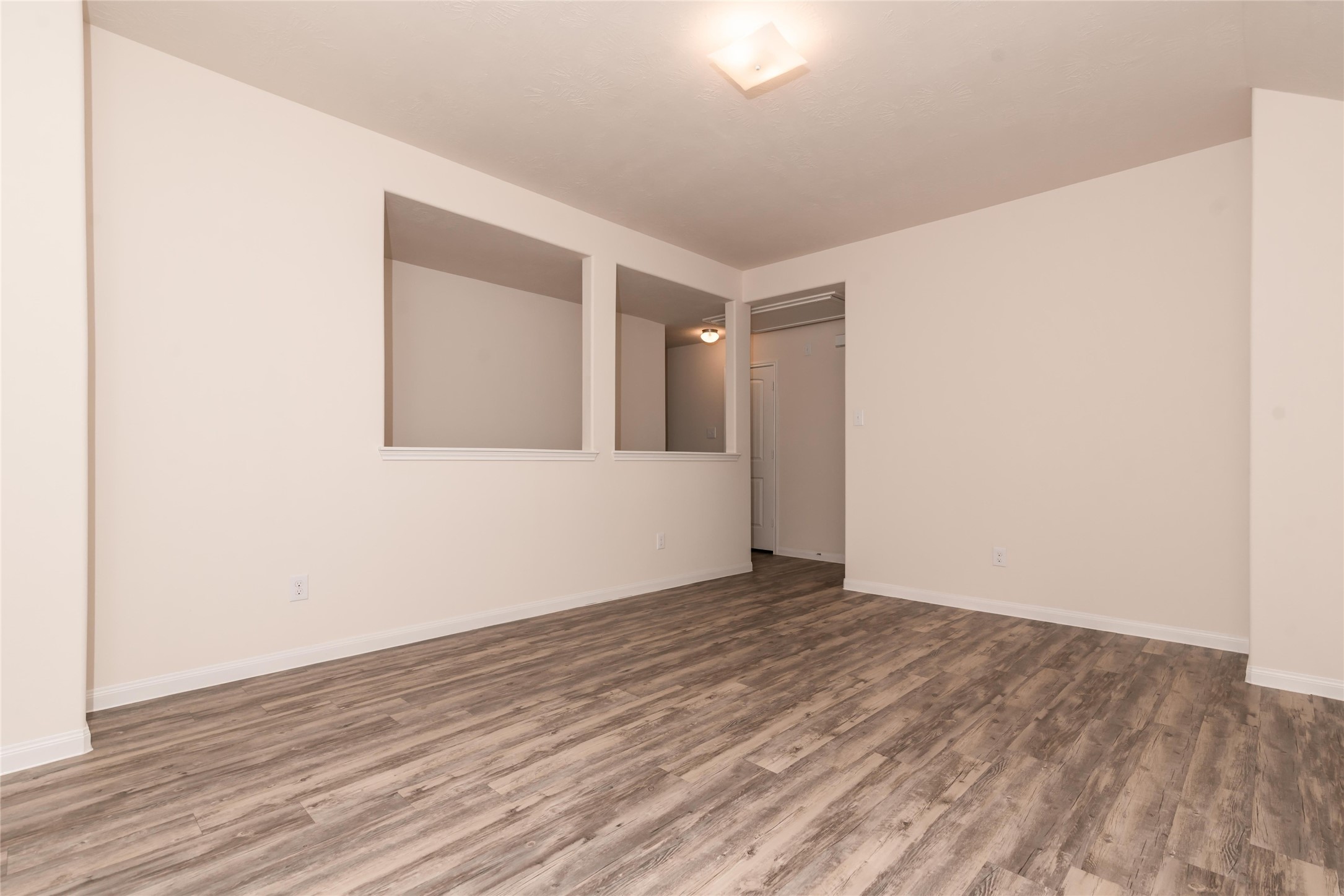 13030 Ristina Circle Houston, TX 77048 - Photo 6 of 10 a view of an empty room with wooden floor and a window