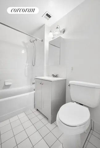 a utility room with cabinets washer and dryer