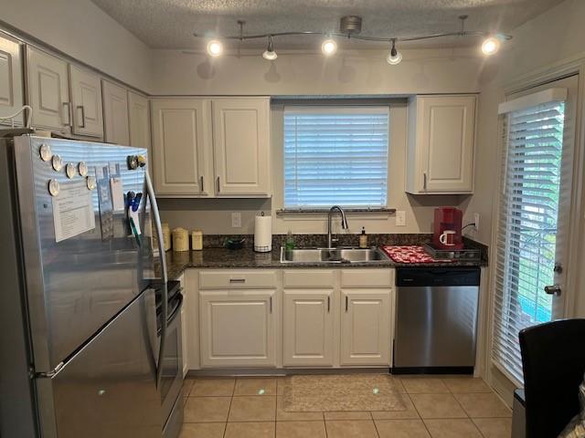 a kitchen with stainless steel appliances granite countertop a stove a refrigerator and a sink