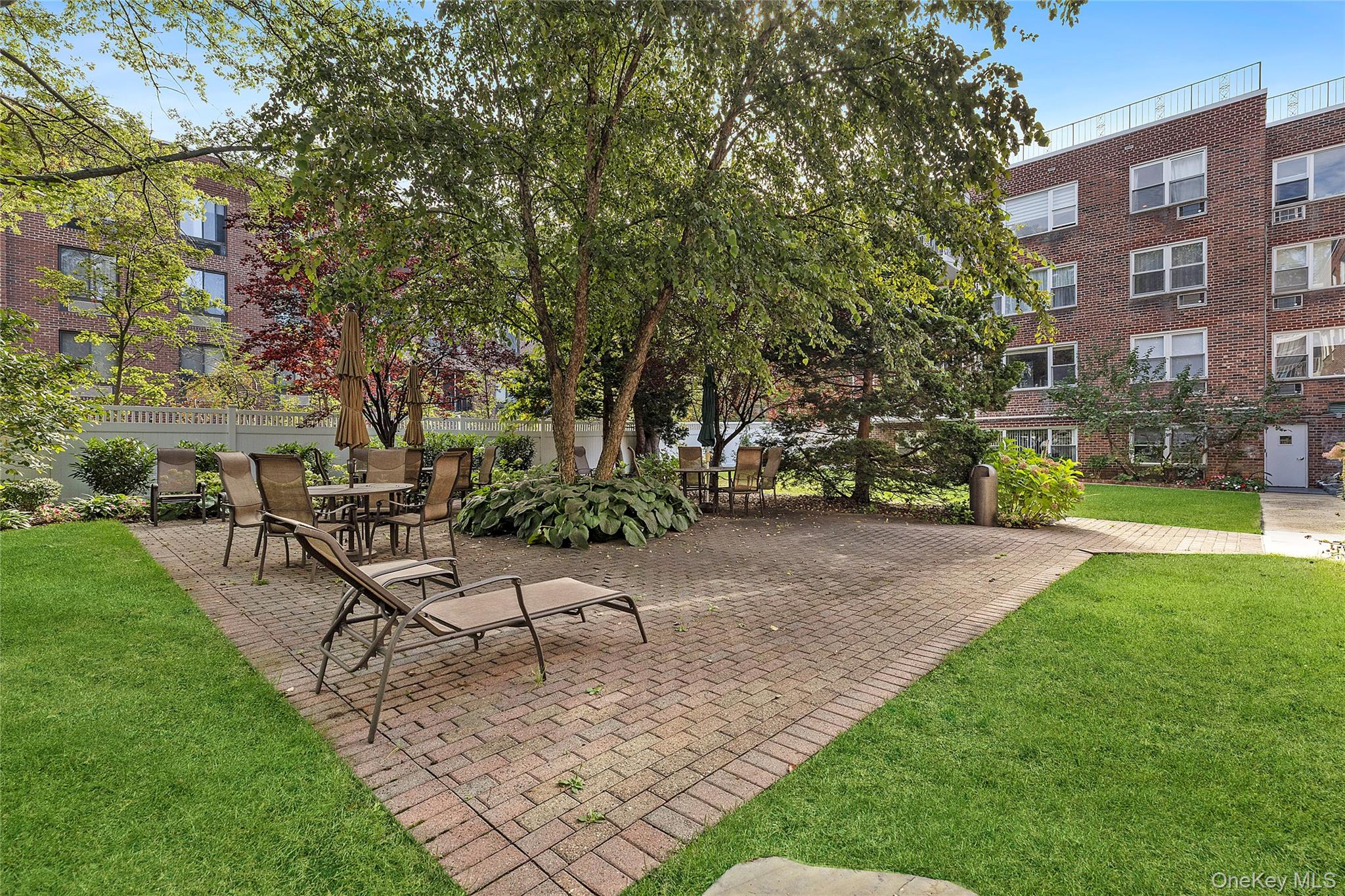 21 Chapel Place, Unit 3M Great Neck, NY 11021 - Photo 14 of 21 View of home's community with a patio