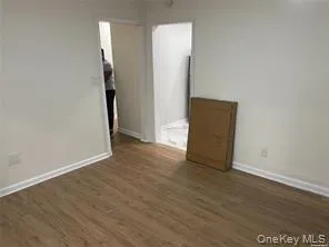 an empty room with wooden floor and a window