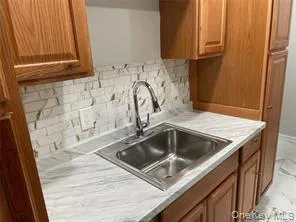 a kitchen with granite countertop a sink and a stove top oven