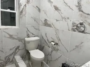 a white toilet sitting next to a bathroom sink