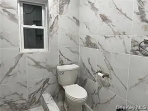 a white toilet sitting next to a bathroom sink