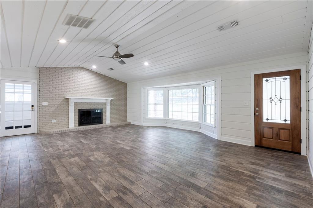 143 Swanson Road Fayetteville, GA 30214 - Photo 15 of 27 an empty room with windows and a fireplace
