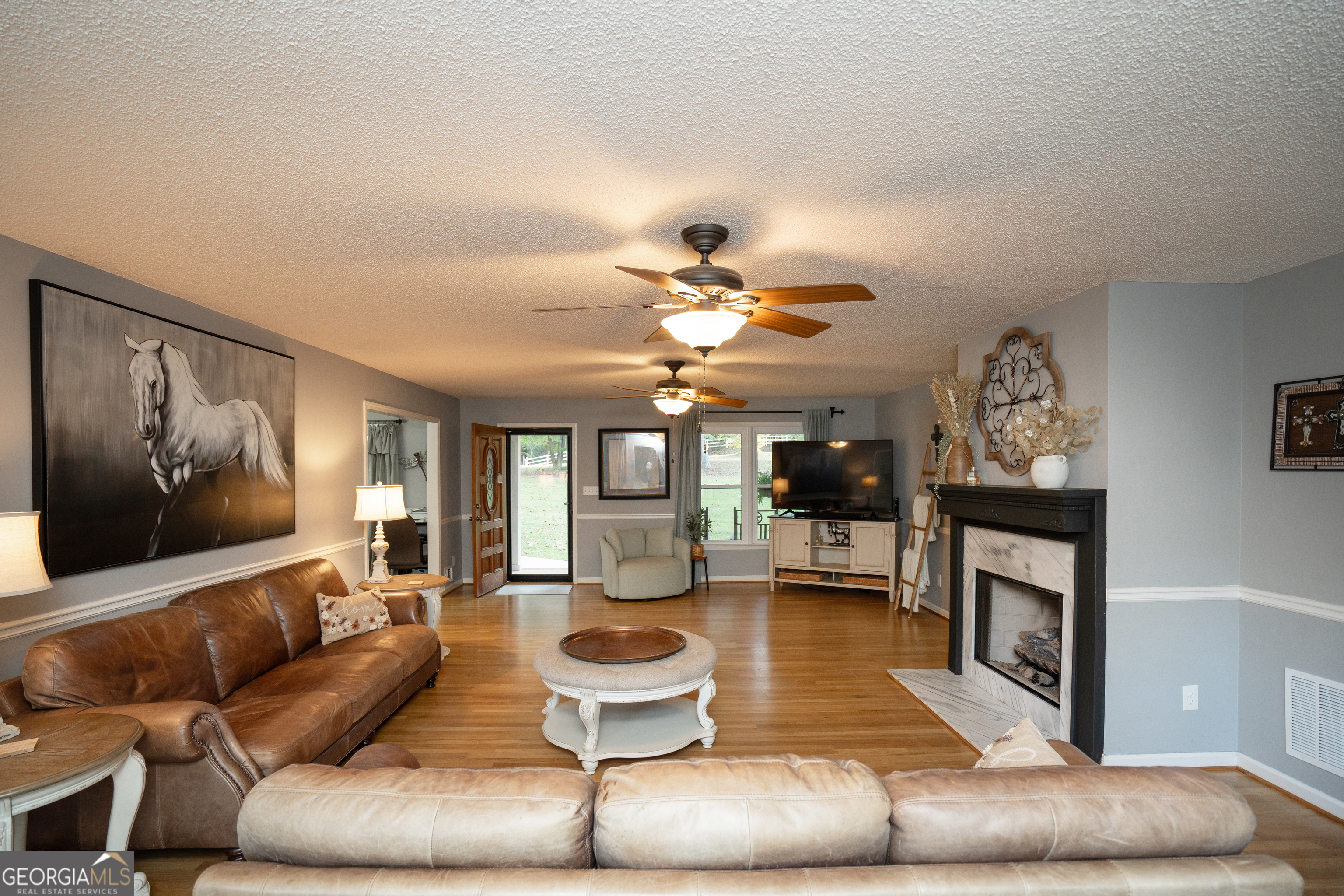 295 Hillview Road Hampton, GA 30228 - Photo 12 of 70 a living room with furniture and a fireplace