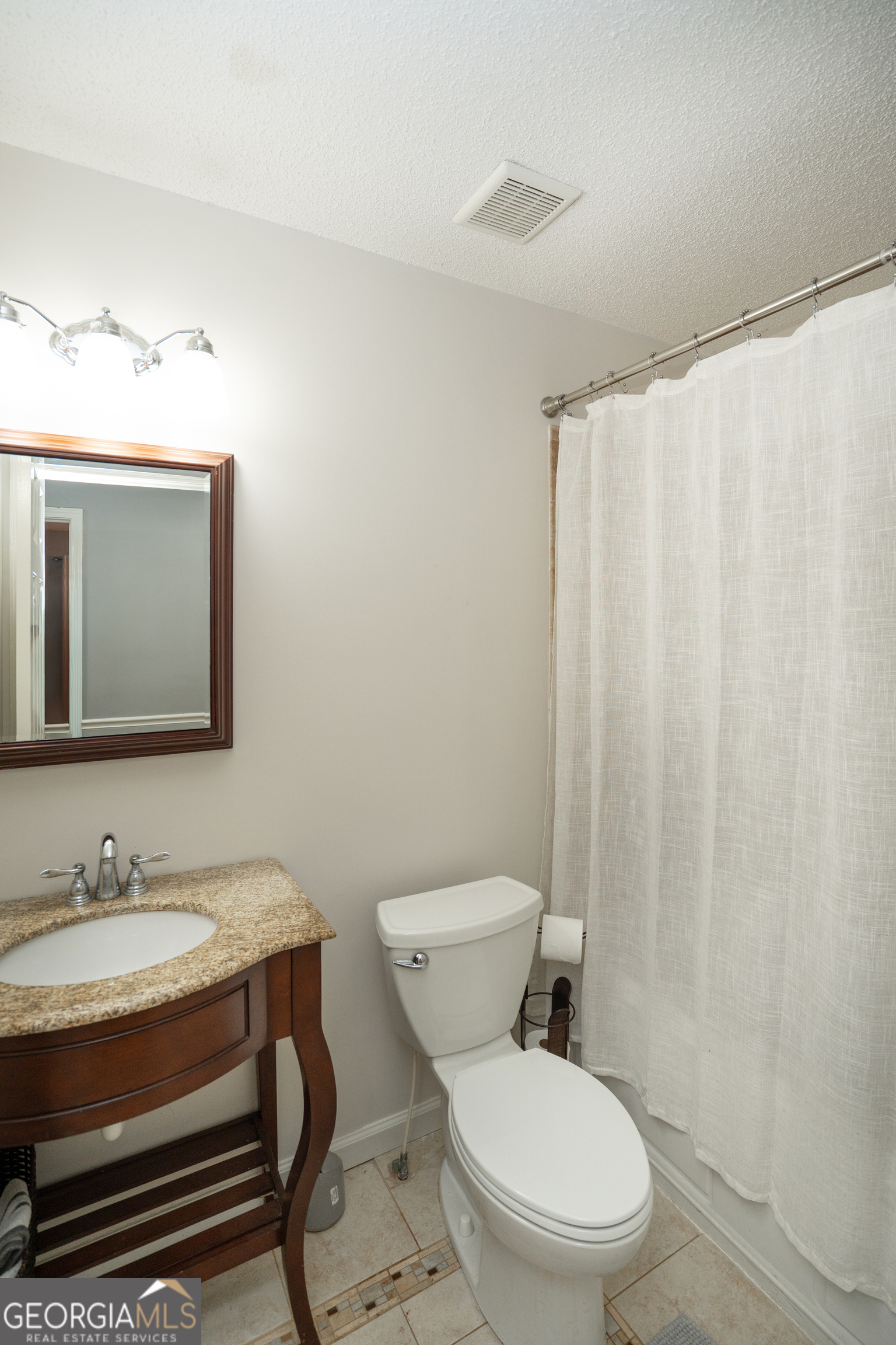 295 Hillview Road Hampton, GA 30228 - Photo 14 of 70 a bathroom with a granite countertop sink a toilet and a mirror