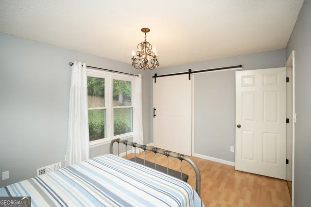 a bedroom with a large bed and a window