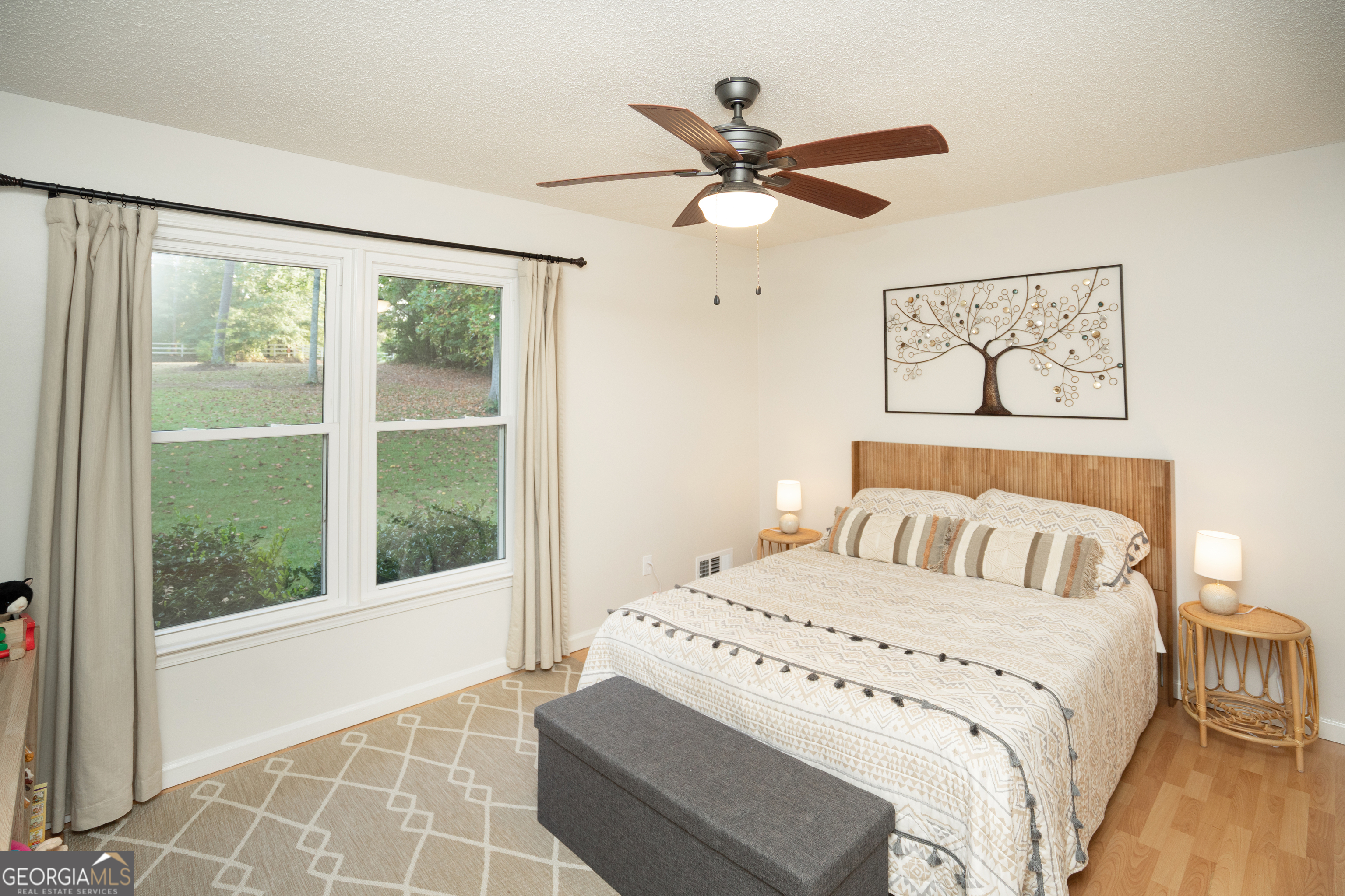 295 Hillview Road Hampton, GA 30228 - Photo 18 of 70 a bedroom with a large bed and a window