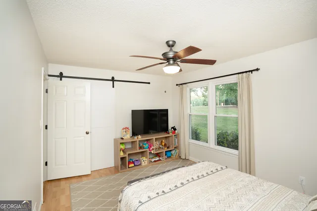 a bed room with a bed and a large window