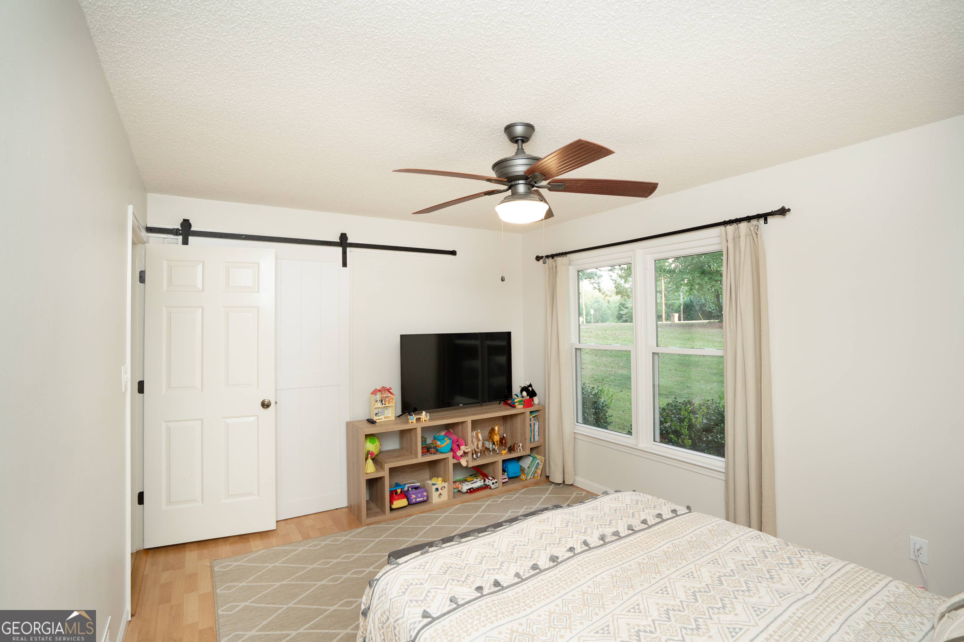 295 Hillview Road Hampton, GA 30228 - Photo 19 of 70 a bedroom with a bed tv and a window